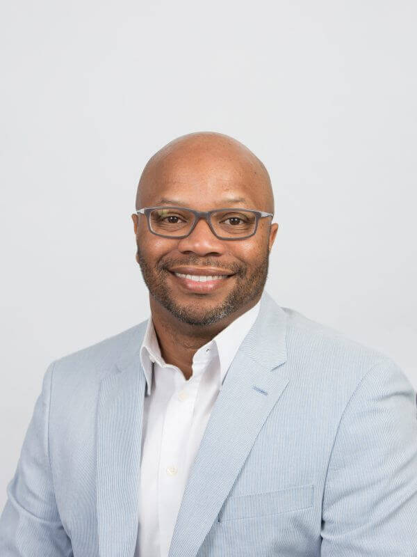 agent Victor Franklin's headshot in a light blue suit with a white button up shirt