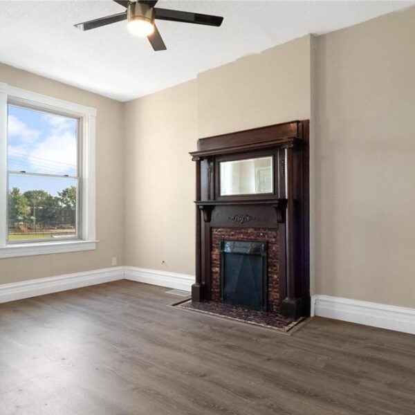 594900 | 4358 Vista Avenue, St. Louis, MO 631104358 Vista living room with a large window on the left and fireplace on the right