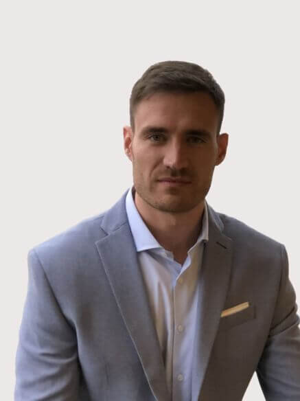 agent Juan Di Salvo's headshot in a gray suit with a white button up