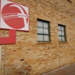 2201 Edwards Building Exterior with red and green business signage