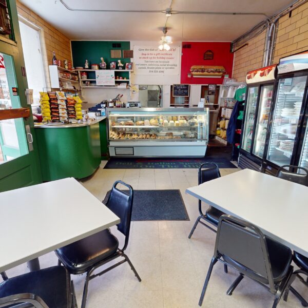 1450000 | 2201 Edwards St., St. Louis, MO 631102201 Edwards Deli Space Front dining Room with two tables and the order Counter