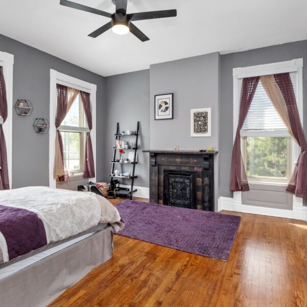 699000 | 1133-1135 Talmage Ave., St. Louis, MO 631101133-1135 Talmage bedroom with decorative fireplace and purple decorative accents