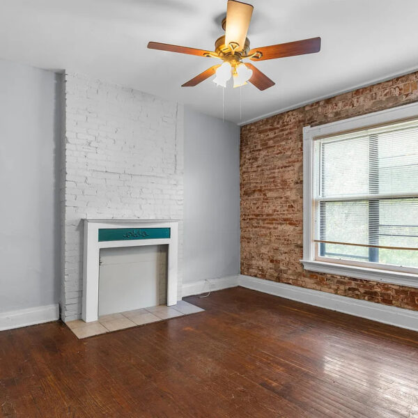 629000 | 4260 Castleman Ave., St. Louis, MO 631104260 Castleman living room with fireplace and large windows on exposed brick wall