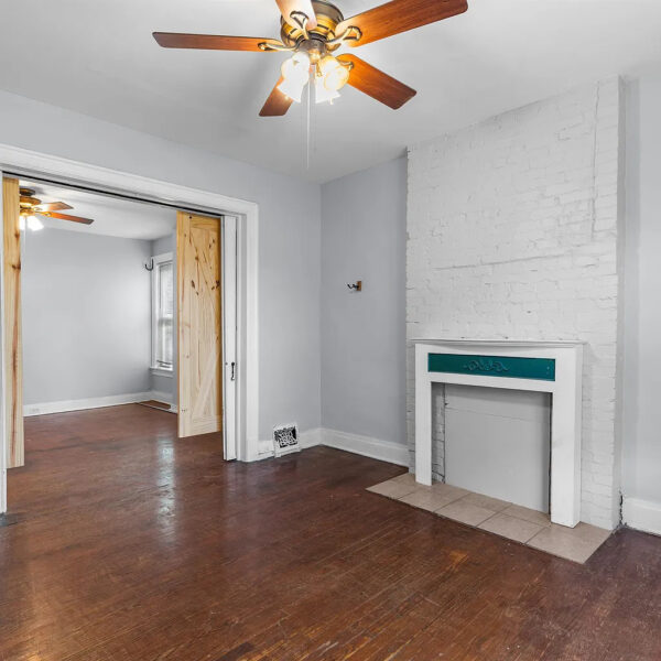 629000 | 4260 Castleman Ave., St. Louis, MO 631104260 Castleman living room with fireplace and open barn doors to another room