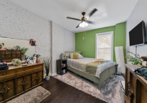 629000 | 4260 Castleman Ave., St. Louis, MO 631104260 Castleman bedroom with a lime green accent wall and painted exposed brick