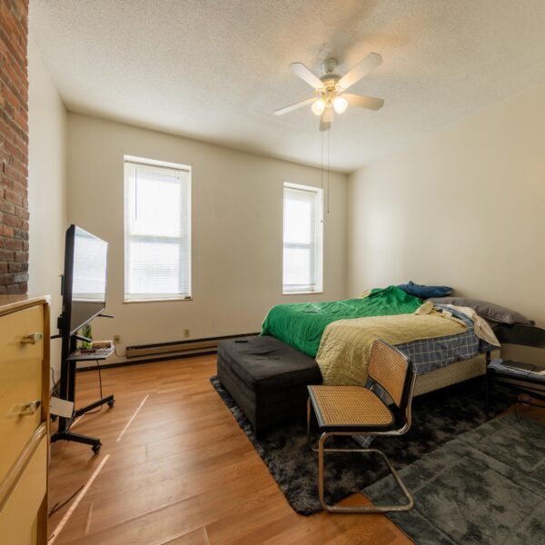 196000 | 3741 Salena St., St. Louis, MO 631183741 Salena bedroom with bed on the right with a green quilt, two windows on the far wall, and dresser on left