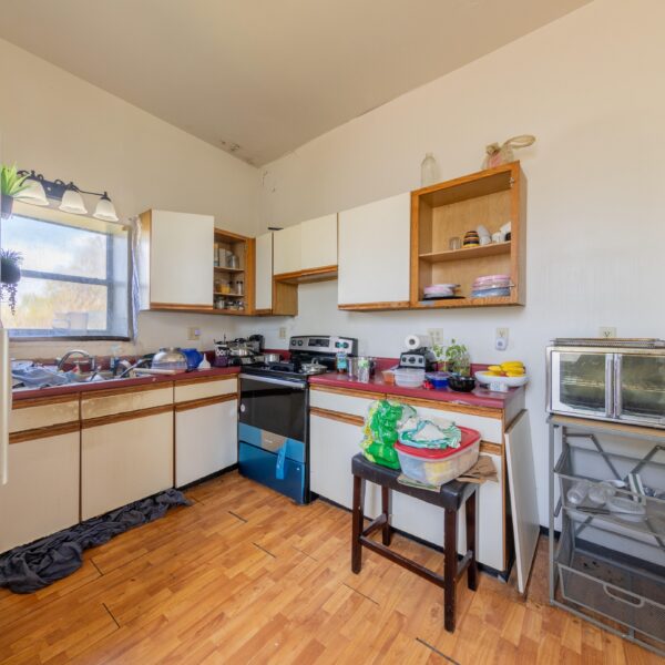 196000 | 3741 Salena St., St. Louis, MO 631183741 Salena open kitchen area with white and wood trimmed cabinets and a small window to the left