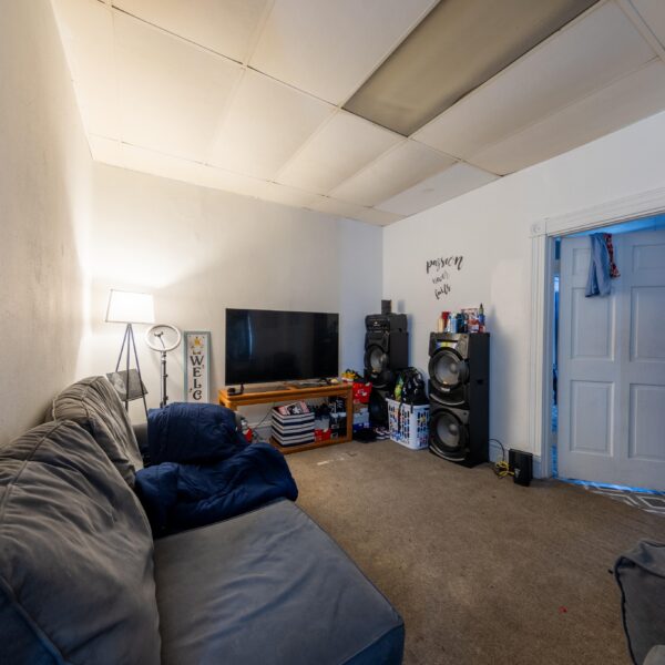 196000 | 3741 Salena St., St. Louis, MO 631183741 Salena carpeted room with a TV on the far wall, couches, and a doorway to a bedroom