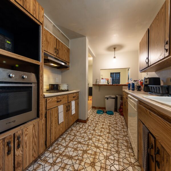 196000 | 3741 Salena St., St. Louis, MO 631183741 Salena alleyway kitchen with an oven built into the cabinets on the left and breakfast bar at the far end