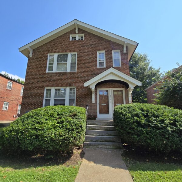 7118 Amherst front exterior with two bushes lining the sidewalk up to the front doors