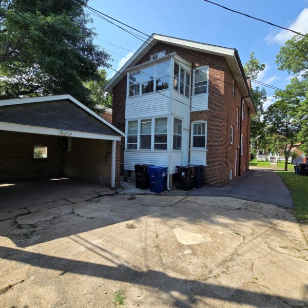 299000 | 7118 Amherst Ave., University City, MO 631307118 Amherst back exterior showing the main building, the garage, and the driveway