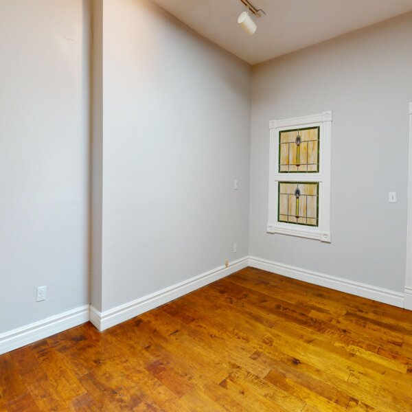 130000 | 2210A Wyoming St., St. Louis, MO 631182210A Wyoming downstairs bedroom from the entry doorway showing a stained glass window on the far wall