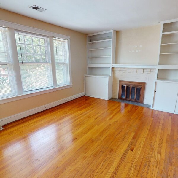 299000 | 7118 Amherst Ave., University City, MO 631307118 Amherst living room area as seen from the entry doorway of a fireplace and built in storage