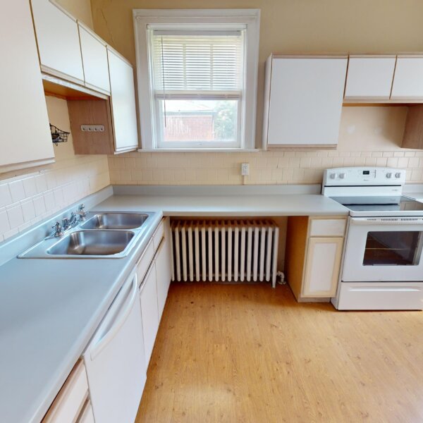 299000 | 7118 Amherst Ave., University City, MO 631307118 Amherst kitchen as shown from the door facing the area with the stove. radiator, and dishwasher