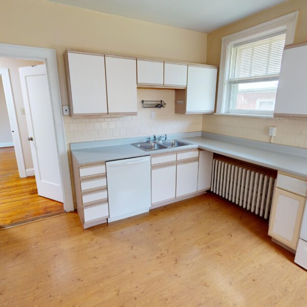 299000 | 7118 Amherst Ave., University City, MO 631307118 Amherst kitchen showing storage on the left by the entry doorway and dishwasher, radiator, and stove to the right