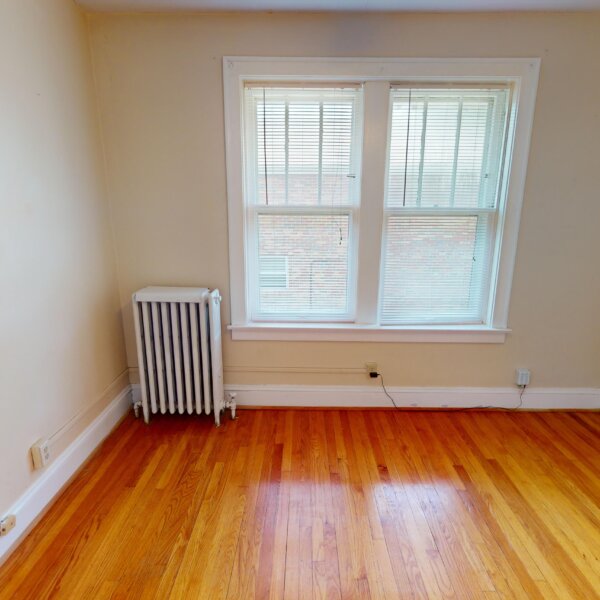 299000 | 7118 Amherst Ave., University City, MO 631307118 Amherst smaller bedroom with a radiator on the left of two windows on the far wall