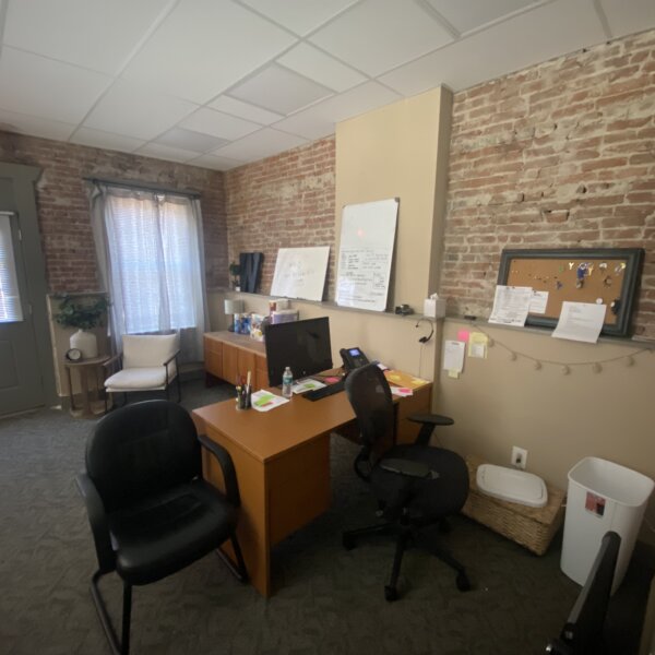 250000 | 901 1st Capitol Dr, St Charles, MO 63301901 1st Capitol half of the front reception area of the office showing desks and exposed brick walls