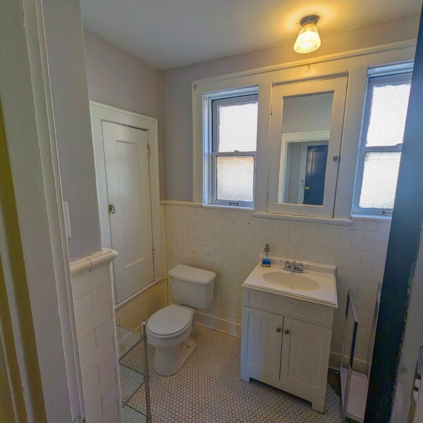 265000 | 5923 South Kingshighway Blvd, St Louis, Missouri 631095923 S Kingshighway bathroom showing toilet and sink with two windows